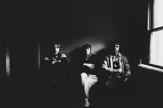 Genesis 1983 official promo photo by Robert Ellis - three members in high-contrast black and white, Mama Tour