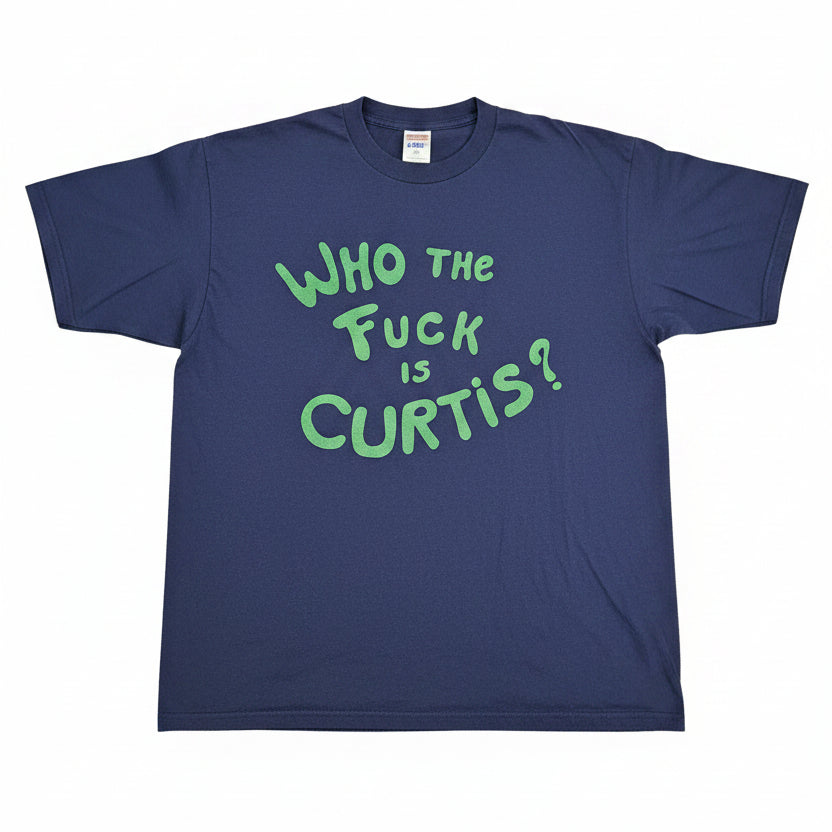 Who The F*** Is Curtis tour crew tee - front with bold green hand-lettered text on navy